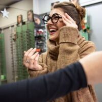 Happy woman at eyewear store